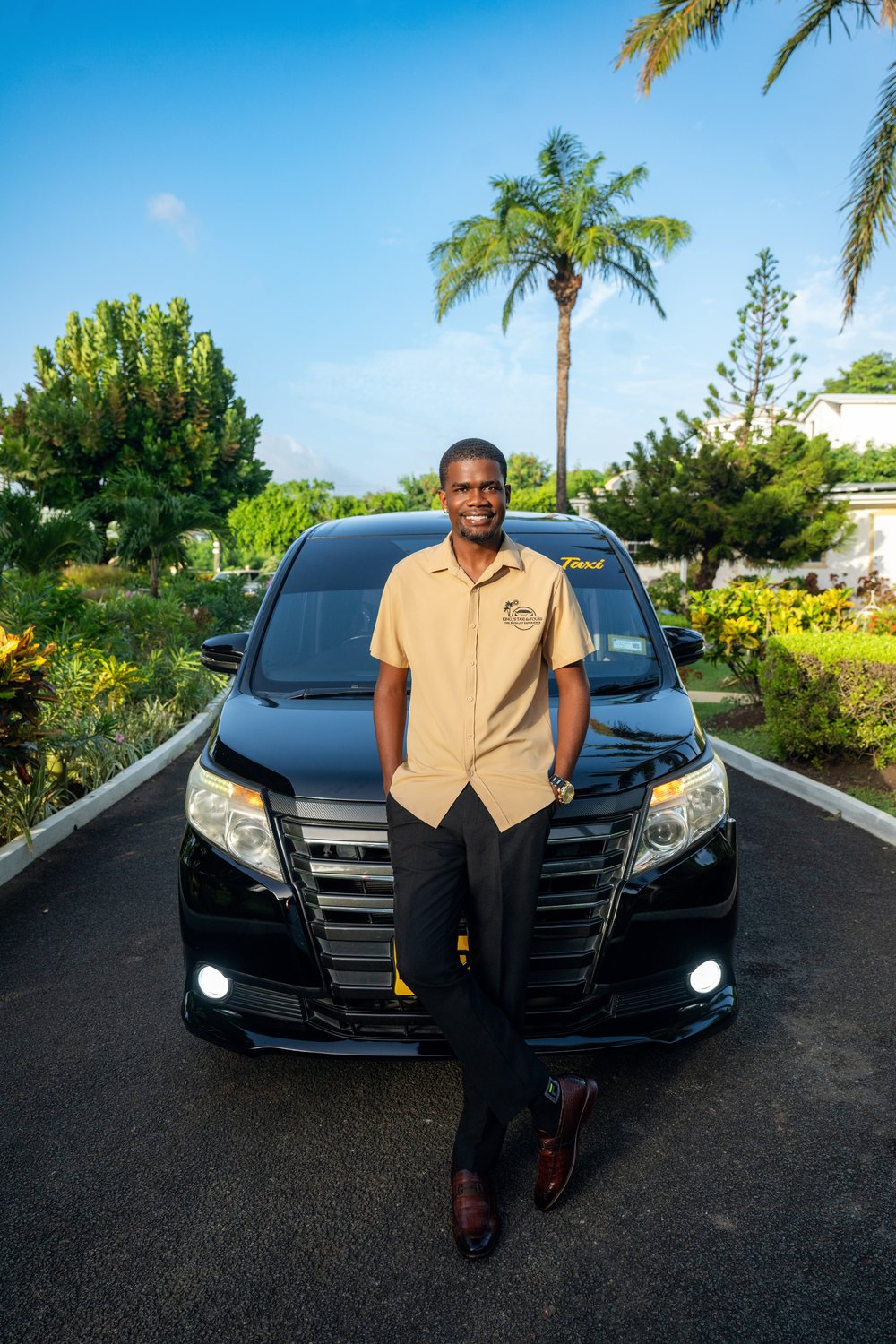 Joel in front of the black King J’s taxi