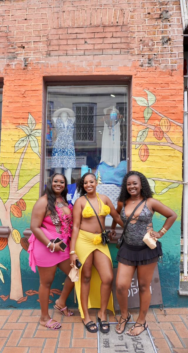 Three guests at a painted shopfront in town
