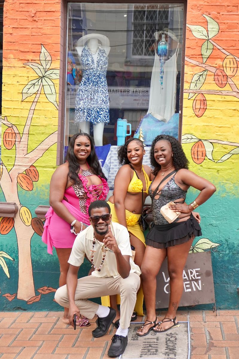 Guests outside a painted shopfront in St. George’s